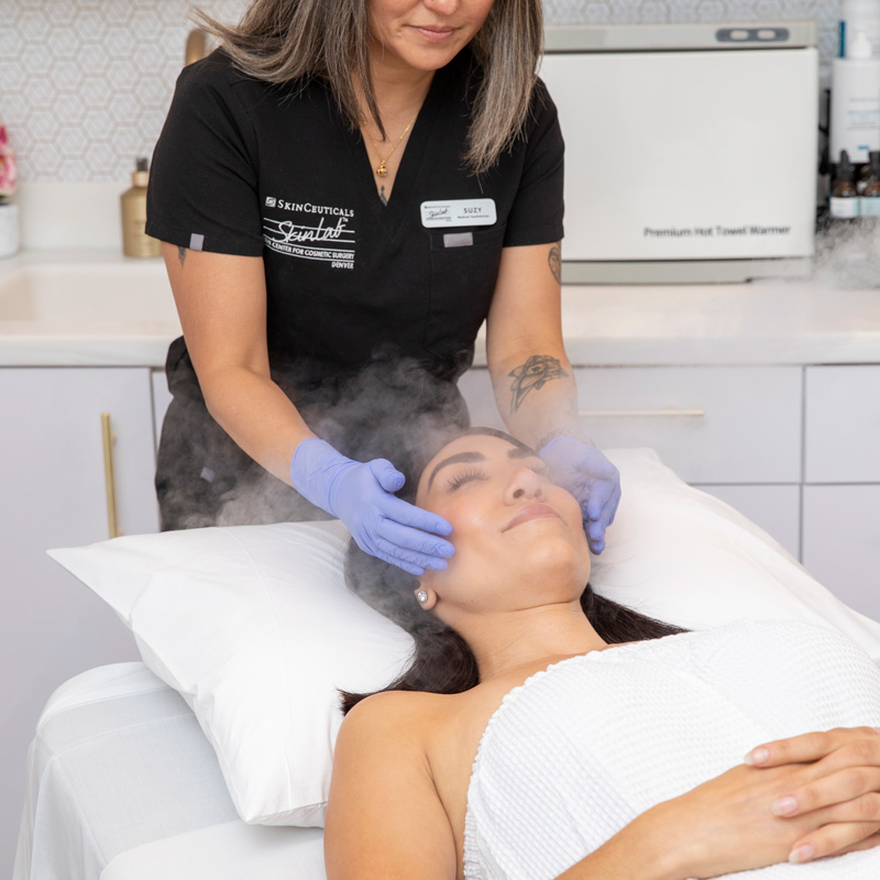 Aesthetic provider performing a relaxing facial treatment for a patient.