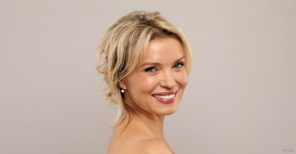 Woman with glowing skin after skin treatments. (Model)